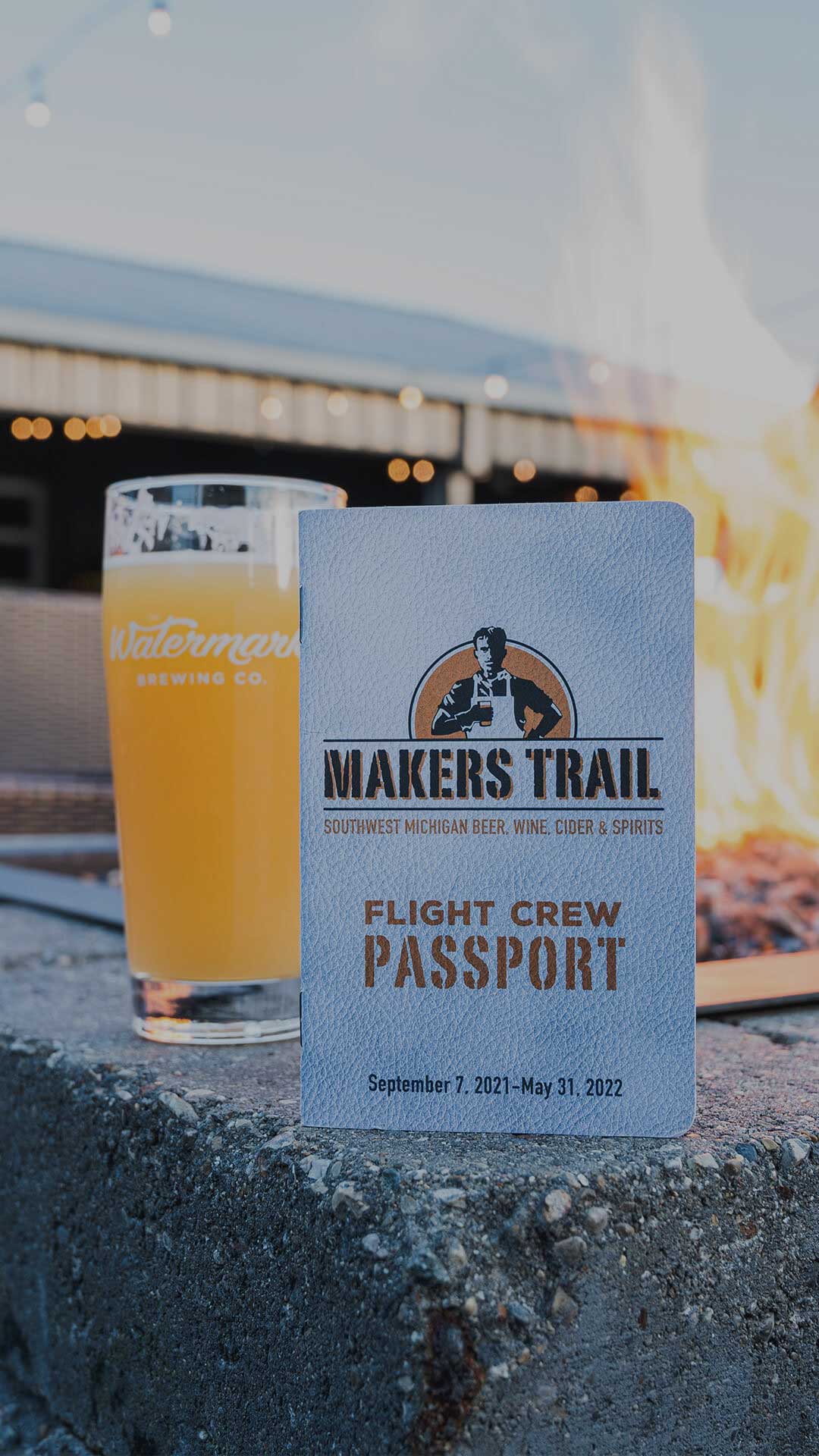 Passport and a beer infront of a fire.